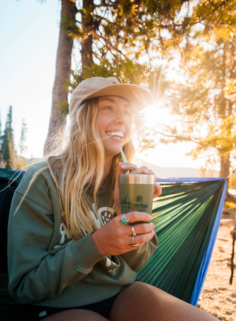 Happy person enjoying a drink with stainless steel tea straw