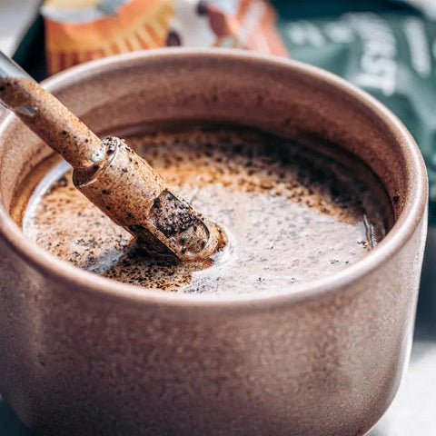 Person holding stainless steel tea straw while drinking yerba mate